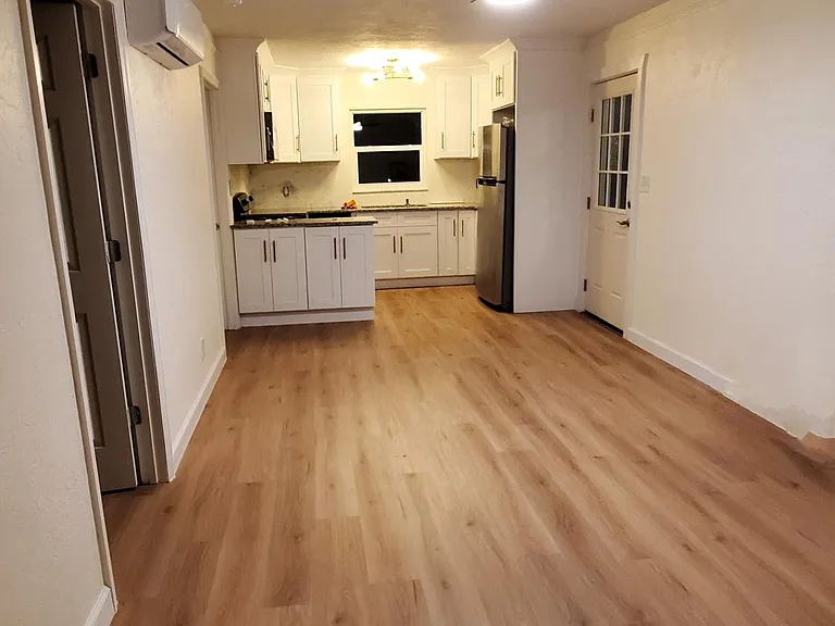 Living room & kitchen area, with LVP floors.