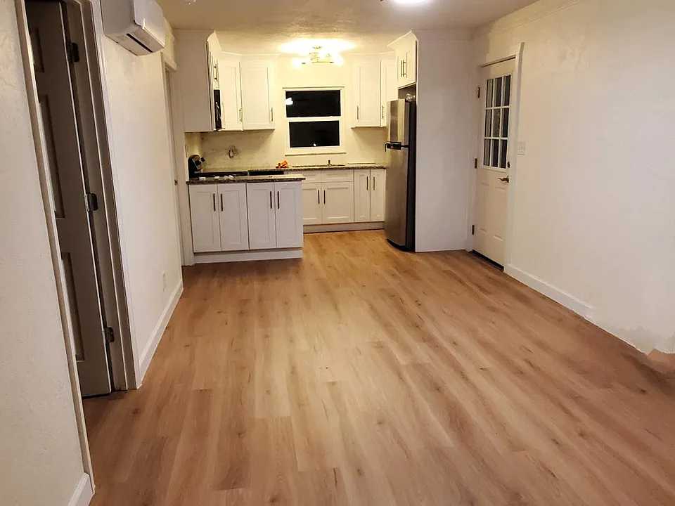 Living room & kitchen area, with LVP floors.