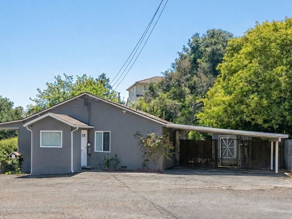 Set against lush greenery, this well-maintained home offers easy single-story flow, ample parking, and a tranquil, tucked-away feel.