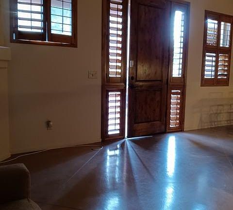 Must see! Includes interior entry with custom high-end stained wooden plantation shutters, windows and door to upscale private community plus many superb retail conveniences with cafes and shops.. Floors are lovely high- polished concrete (custom -stain