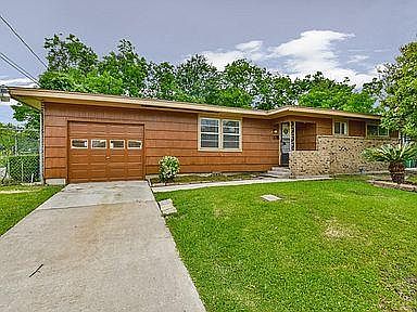 Front of house with off street parking and garage