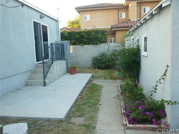 Area between the house and the detached 2 car garage.