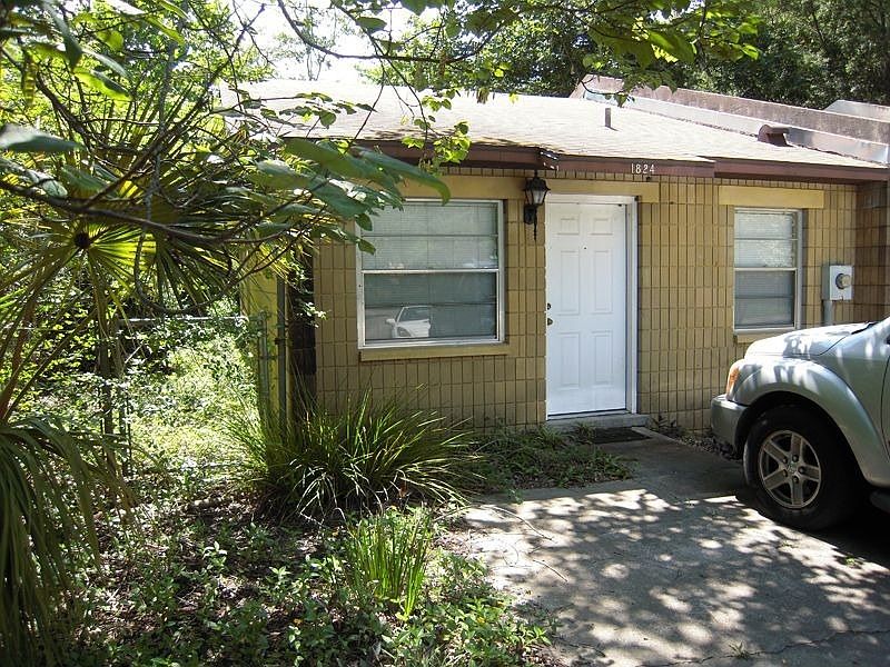 Exterior view with fenced yard on side and shows on street parking.
