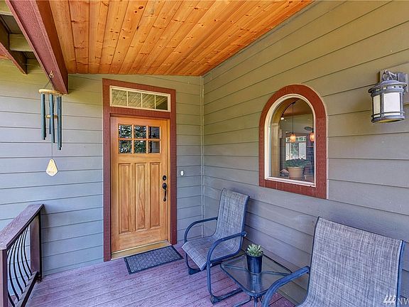 Gorgeous entry with arched windows, Trex decking, metal spindle railings, custom doors & more!