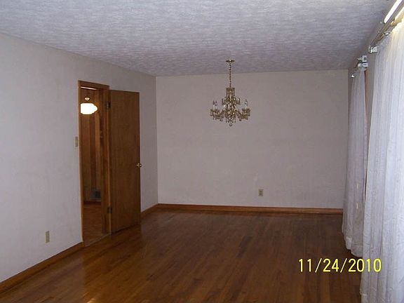 view from living area to dining area- door into kitchen