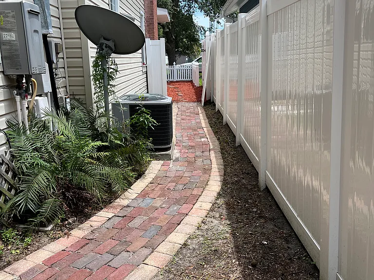 back of the house path on the left of the house, new fencing from neighbors, matching the front of the house too
