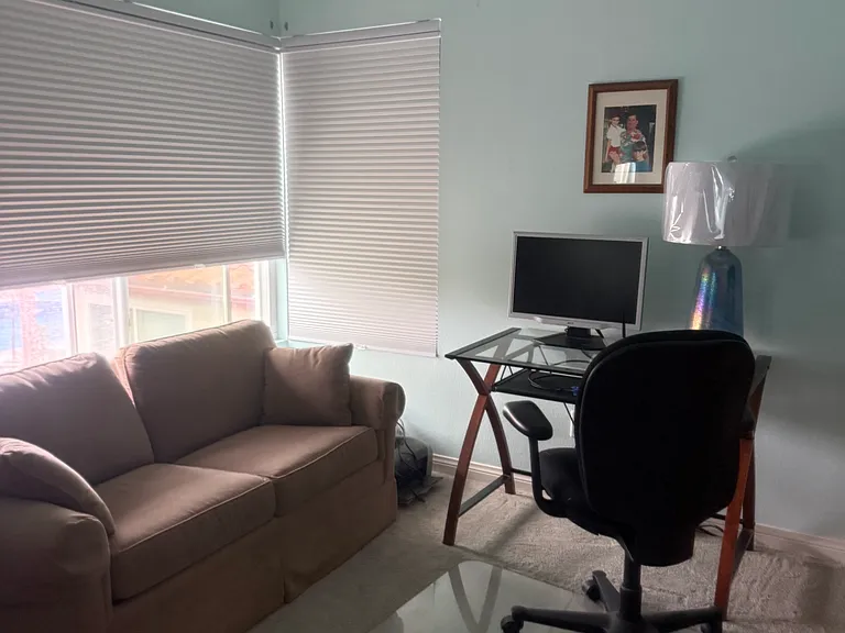 Sitting area and desk-primary bedroom. Lots of natural light creates a soothing environment