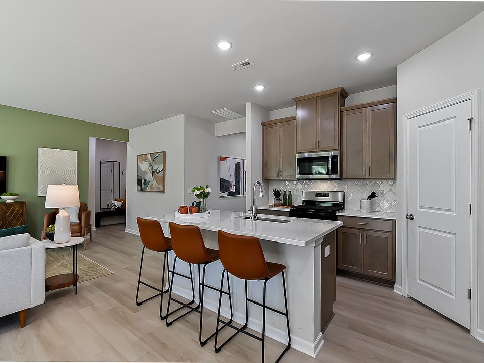 The kitchen provides ample prep and storage space with a sizeable island overlooking the great room.