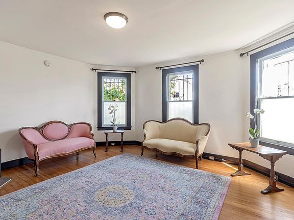 Living room. Refinished original oak floors. Gas wall heater. Sunny and bright with tons of natural light. Fresh paint.