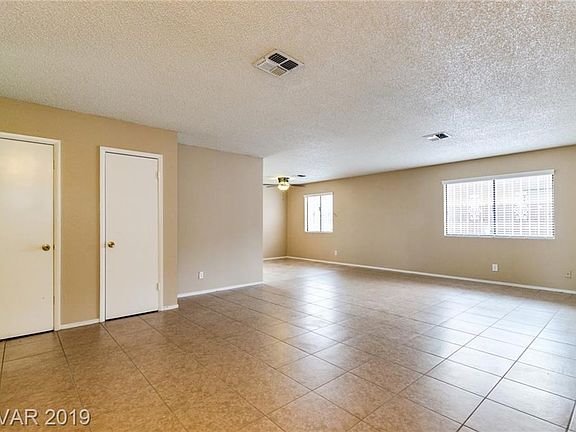 Large living and dining room area with tile floors...