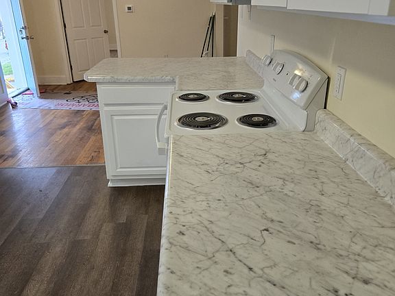 Kitchen, new countertops, lots of new cabinets, stove and overhead microwave