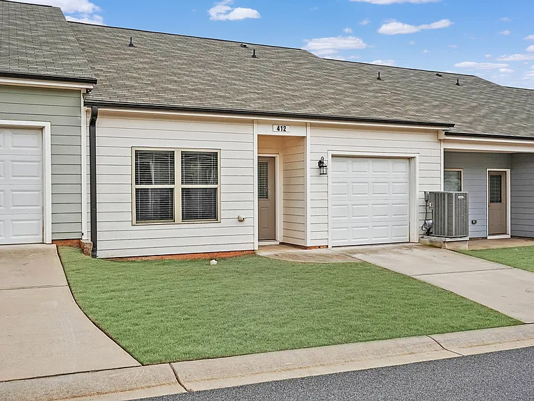 Exterior of the Franklin, ranch-style cottage home with a private driveway and attached garage.