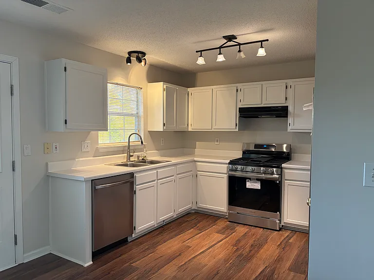 Kitchen with new appliances including new stove and fridge. Also new dishwasher.
New faucet and new garbage disposal