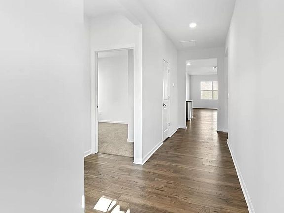 Entry hallway with a small mud closet to the left. Moving further down the hall, you have two oversized bedrooms with a full bathroom.
