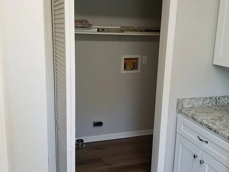 Laundry closet next to kitchen