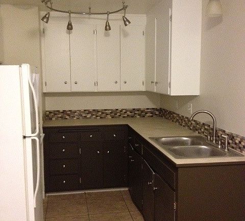 Kitchen photo. Lower cabinets in unit for rent are white, m