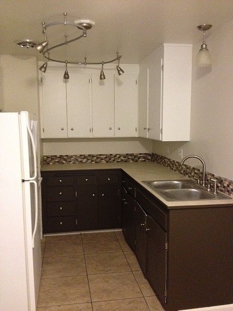 Kitchen photo. Lower cabinets in unit for rent are white, m