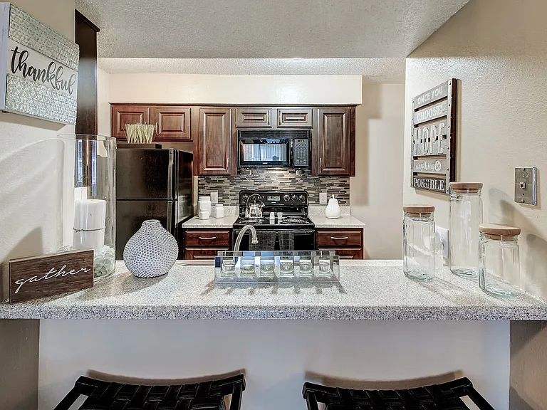 Stunning eat in kitchen with espresso cabinets and modern backsplash