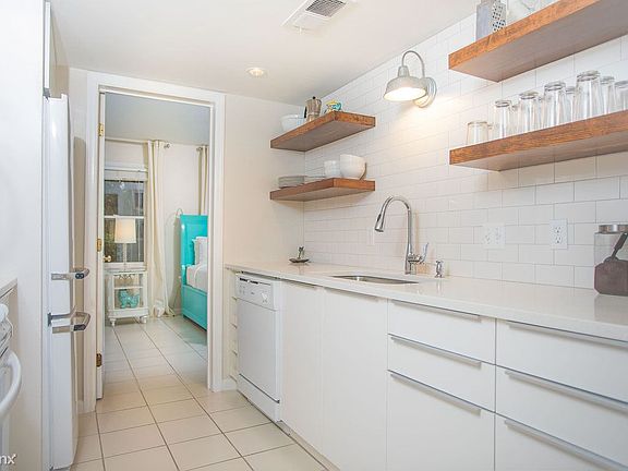 The kitchen has open shelving ample counter space.