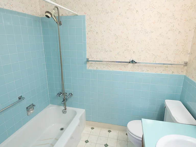 Original bathroom bathtub, toilet, shower, and sink.