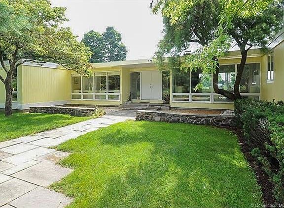 Walk into a beautiful bright foyer with floor to ceiling windows
