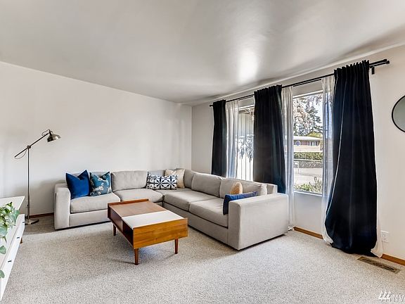 Another angle, living room, with large windows emphasizing your fully fenced front yard.
