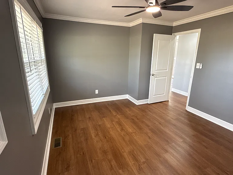 Master bedroom view from closet area and Bluetooth ceiling fan.