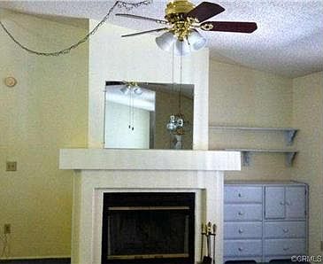 living room fire place and ceiling light fan