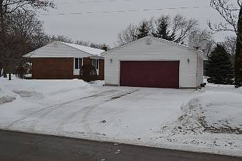 Secondary view of the outside of the home showcasing the wide driveway and 2.5 car garage.