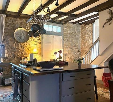 Large Wood Kitchen Island with 3 Comfortable Stools, Pot & Pan Rack, Natural Stone Walls, Spacious High Ceilings