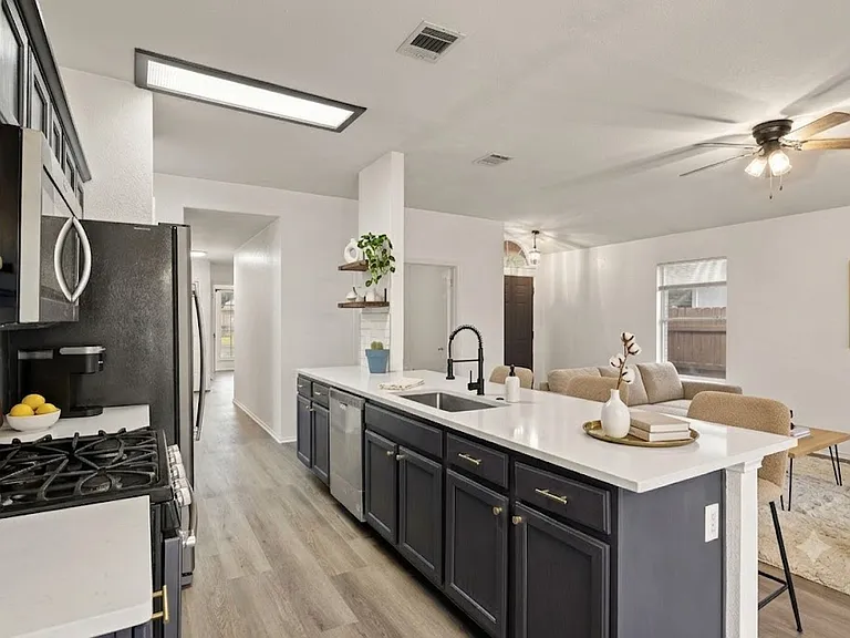Remodeled open concept kitchen with stainless steel appliance, quartz countertops and subway tile backsplash