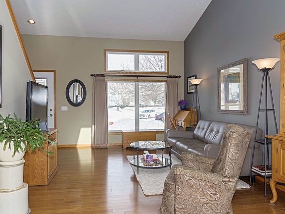 Main floor living area with vaulted ceilings and hardwood flooring
