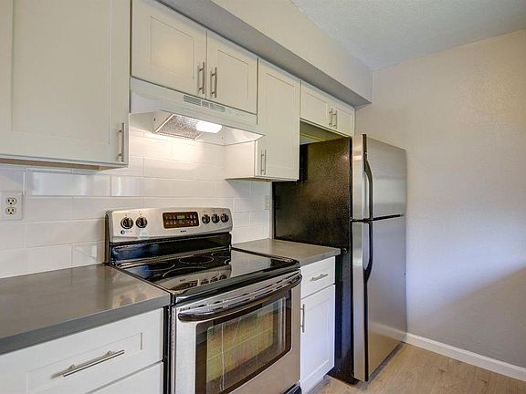 Kitchen has full size refrigerator/freezer with quartz counters