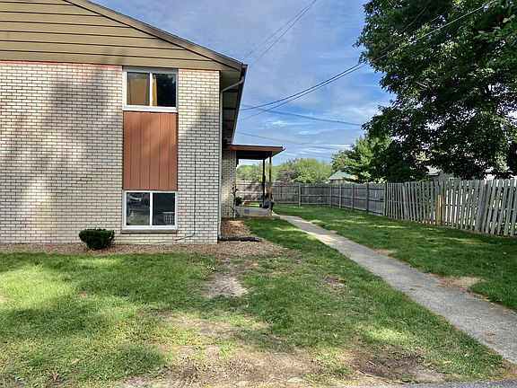 Backyard with sidewalk to back entrance.