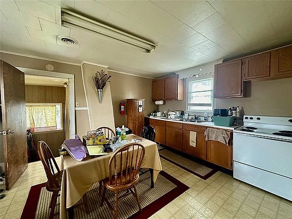 Kitchen will be freshly painted with a tile backsplash.