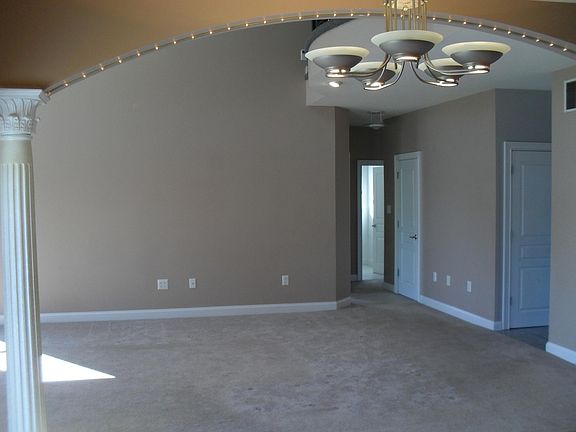 Looking into family room from kitchen. (Note hanging lights in kitchen)