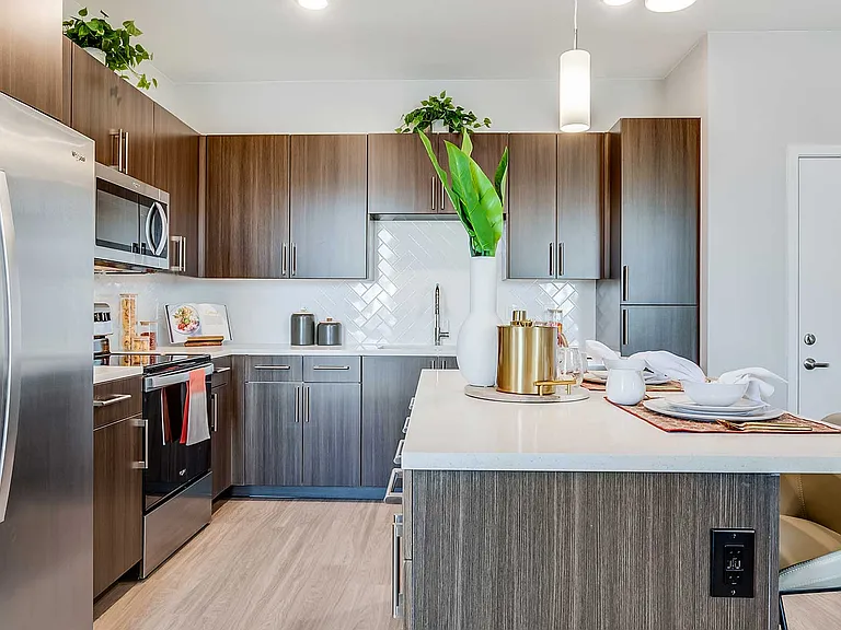 Each apartment home at The Wright features a modern kitchen with stainless-steel appliances, sleek cabinetry, quartz-style countertops, and spacious islands.