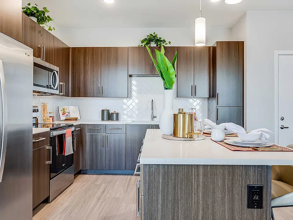 Each apartment home at The Wright features a modern kitchen with stainless-steel appliances, sleek cabinetry, quartz-style countertops, and spacious islands.