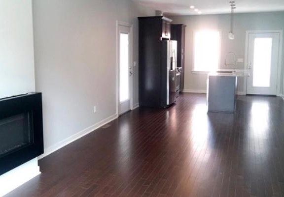 Side view showing floor plan, doorway to left leads to fenced patio. Off kitchen at the end of the hall is a small patio space, 