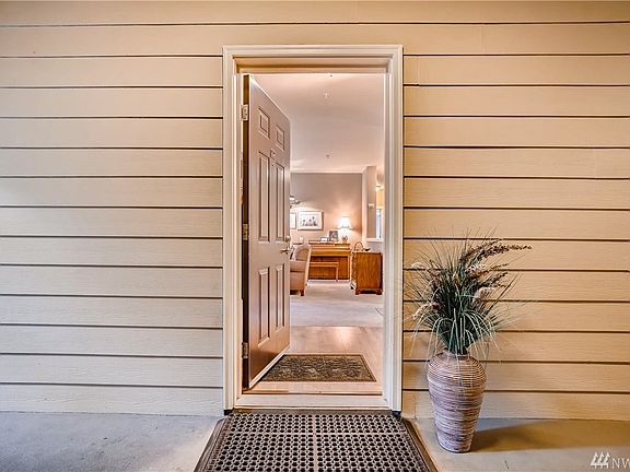 Entry with wood flooring and large guest coat closet. The condominium is located on the second floor in Building 2. There are 12 condominiums in this building...four on each floor.  Each condominium has it's own entrance and all are corner units for privacy.