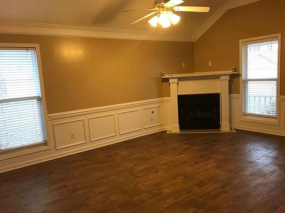 Living room with fireplace and 2 windows