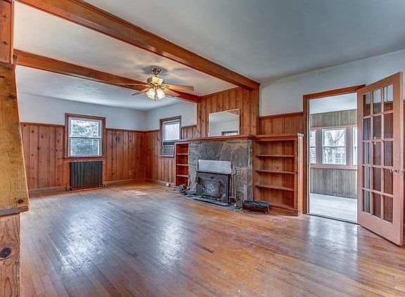 Large living room has stone fireplace & built-ins