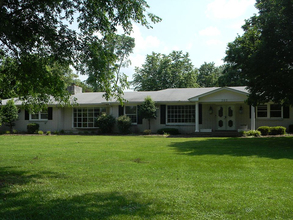 White brick home located on acre lot