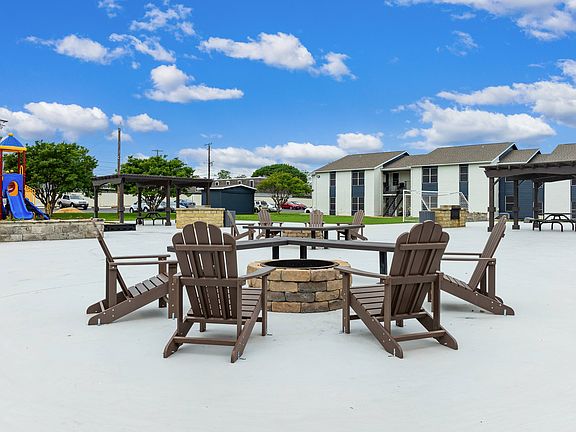 Relaxing Outdoor Fire Pit Area with Adjacent Amenities in Waco Apartments