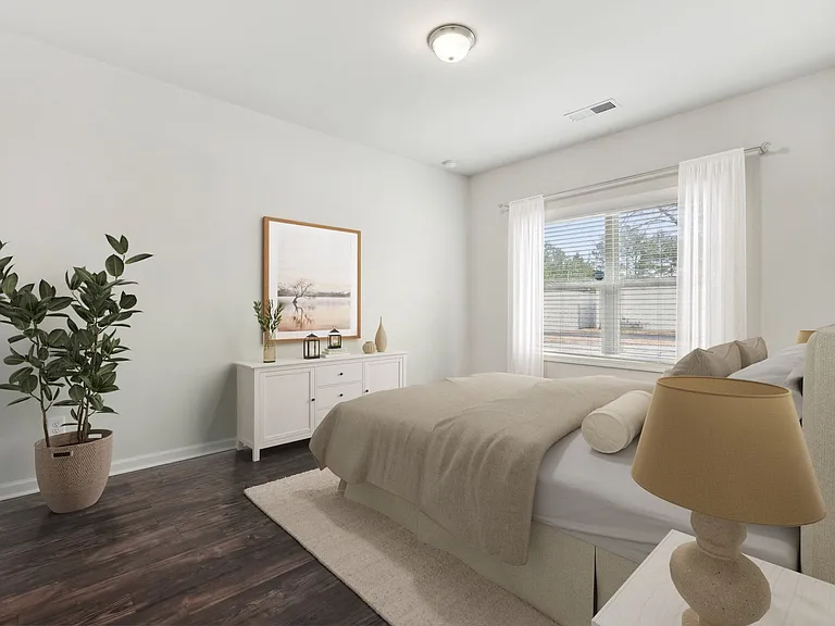 Primary Bedroom with king size bed and large window letting in nice natural light.