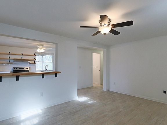 Open concept living room facing TV wall