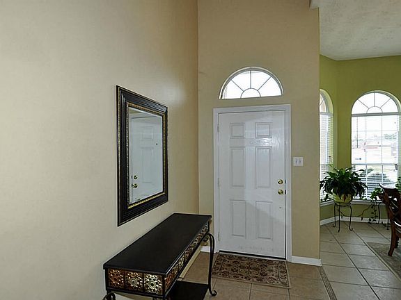In Foyer area looking back at front door with Formal Dining room to the side.