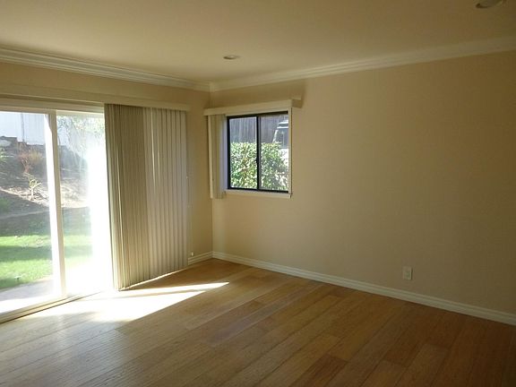 Family Room with crown moulding, recessed lighting, and access to rear yard.