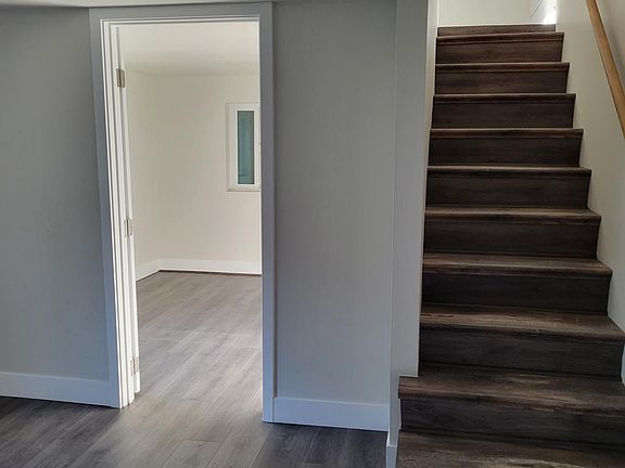 On the bottom floor/steps to upstairs, there is a room
