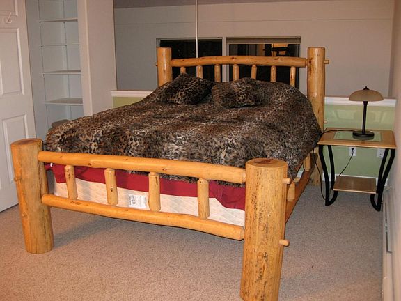 log bed in loft, west window in background
